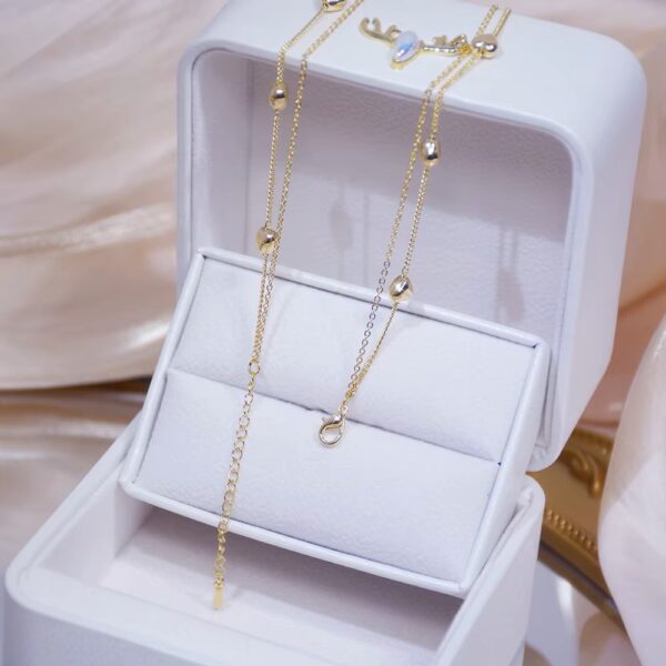 a jewelry box with a chain necklace in it